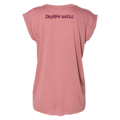 Rose colored women's drapey tee with Tauren Wells logo on upper back